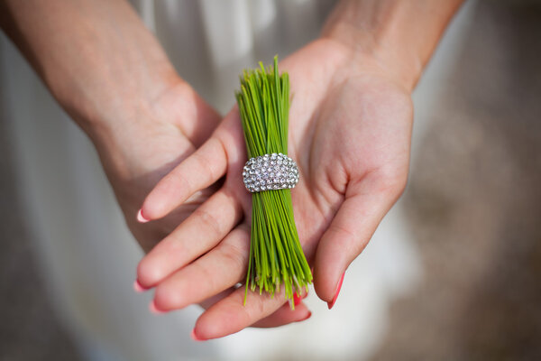 pine needles with a ring in the hands of girl