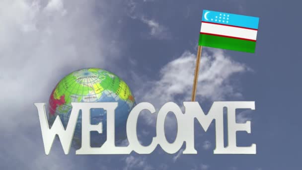 Поворотний глобус і невелику паперову прапор Узбекистану — стокове відео