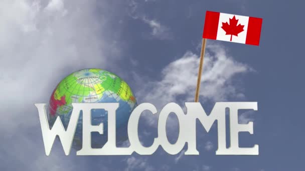 Turning globe and small paper flag of CANADA — Stock Video