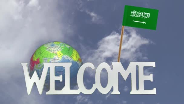 Turning globe and small paper flag of SAUDI ARABIA — Stock Video