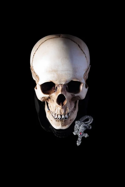 Human skull with silver cross — Stock Photo, Image