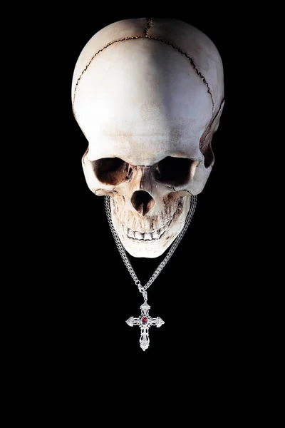 Human skull with silver cross — Stock Photo, Image