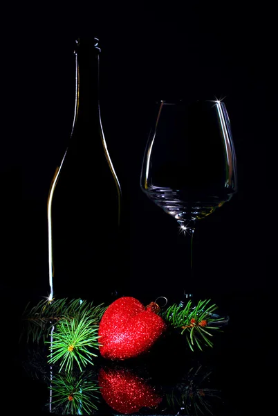 Wine bottle and glass with christmas decorations — Stock Photo, Image