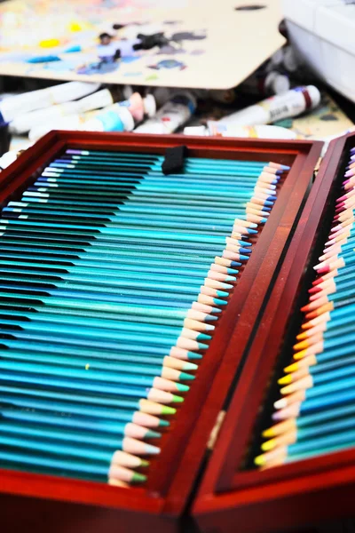 Colorful art pencils in a wooden case — Stock Photo, Image