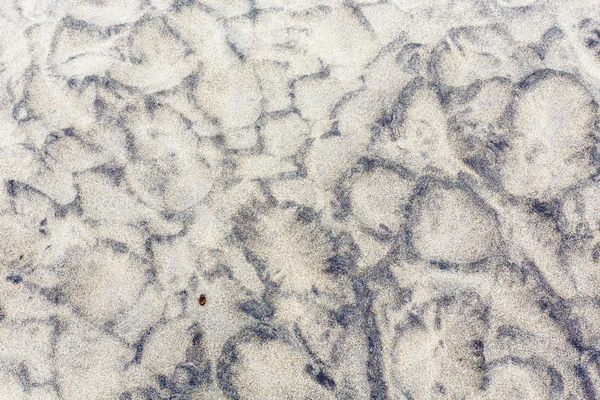 Steen bedekt zand, achtergrond. — Stockfoto