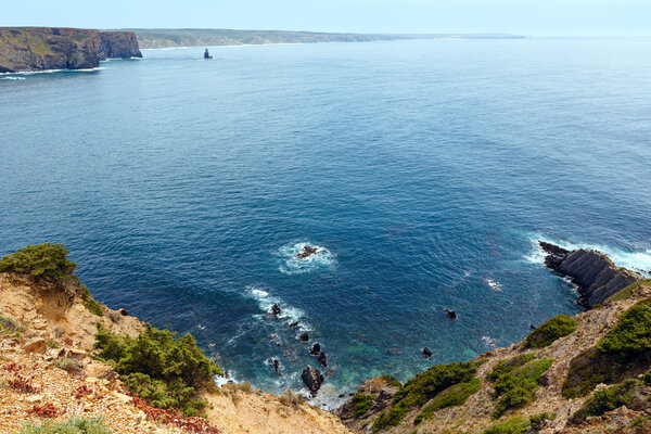 Summer Atlantic ocean rocky coastline (Algarve, Portugal).