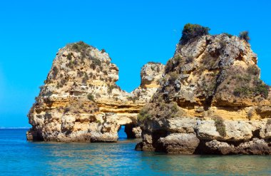 Sarı kayalıklarla plaj (Algarve, Portekiz yakın).
