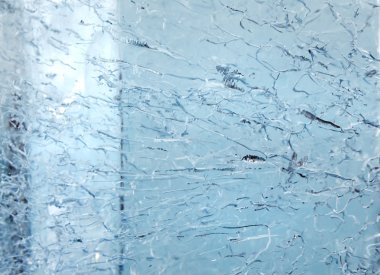 Glacial transparent wall of ice with patterns. clipart