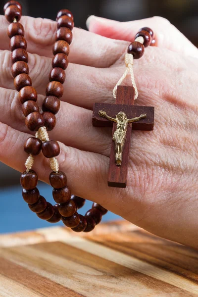 Rosary beads in hand — Stock Photo, Image