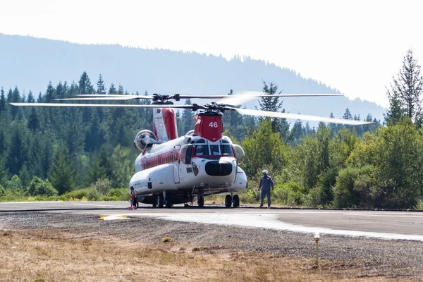 Chinook helicopter and fire crew — Stock Photo, Image