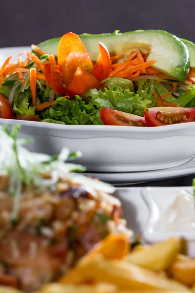 Chicken fried rice with fries and a salad — Stock Photo, Image