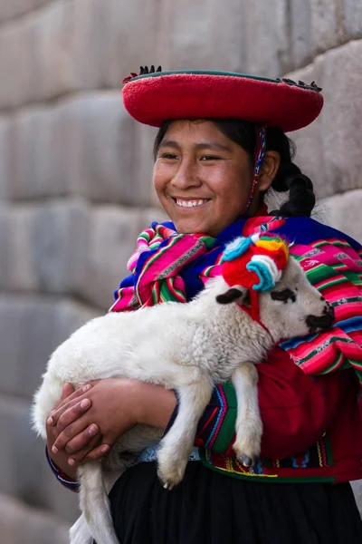Native Peruvian holding a baby lamb — Stock Photo, Image