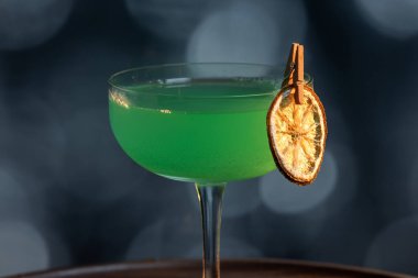 Ahşap tepside canlı renkte, sert dramatik ışıklandırmalı klasik yeşil içecek.