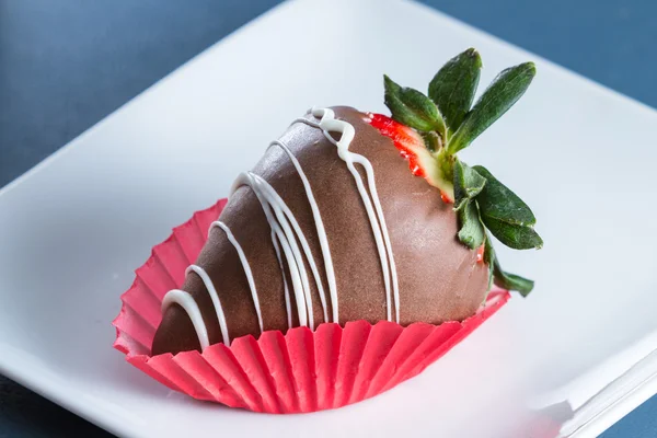 Chocolate covered strawberry on a white plate — Stock Photo, Image