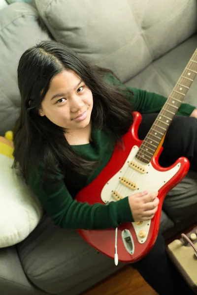 Felice ragazza sorridente, imparare a suonare la chitarra elettrica — Foto Stock