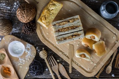 Ahşap bir masa üzerinde un ile pişmiş ekmek çeşitleri 