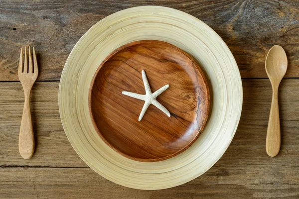 The brown wooden bowl on a rustic table with Star fish — Stock Photo, Image