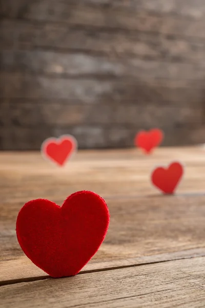 Red Valentine hearts on old rustic wooden background — Stock Photo, Image