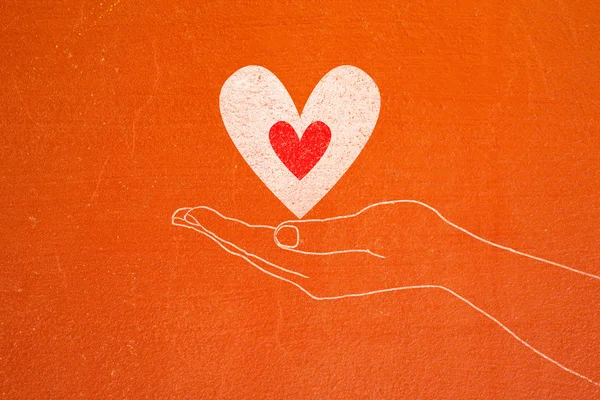 Hand holding stick with Heart ,hand drawn on cracked concrete — Stock Photo, Image