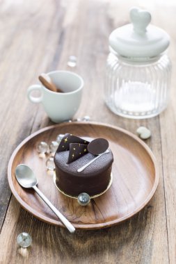  Dark chocolate cake on wooden background