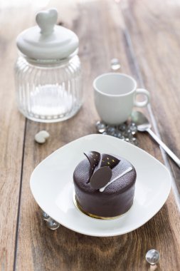  Dark chocolate cake on wooden background