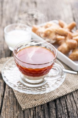 Breakfast with tea , soft boiled egg and  deep-fried dough stick on wooden table,selective focus