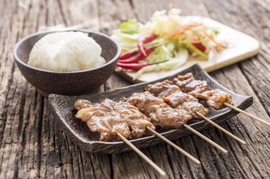 roasted pork with white sticky rice on wooden table