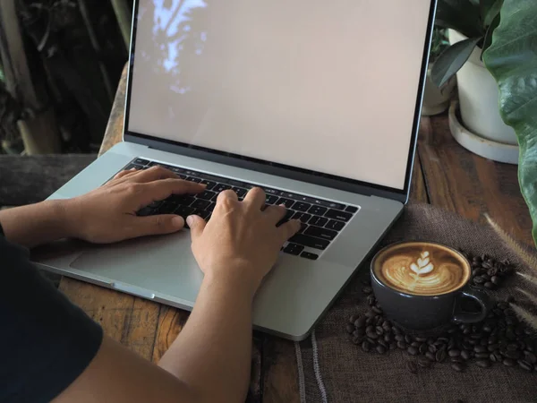 Cup of coffee with beautiful Latte art. Coffee cup with latte art on the wood table.