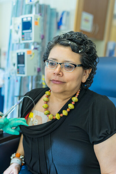 Hispanic Female Waits Patiently During Chemo Treatment Infusion