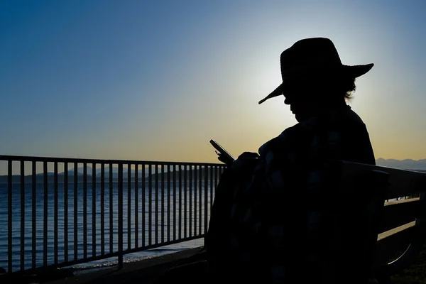 Female At Beach Sitting And Reading Silhouette — Stock Photo, Image