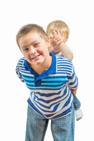 Loving Big Brother Carries Little Brother On His Back Royalty Free Stock Photos