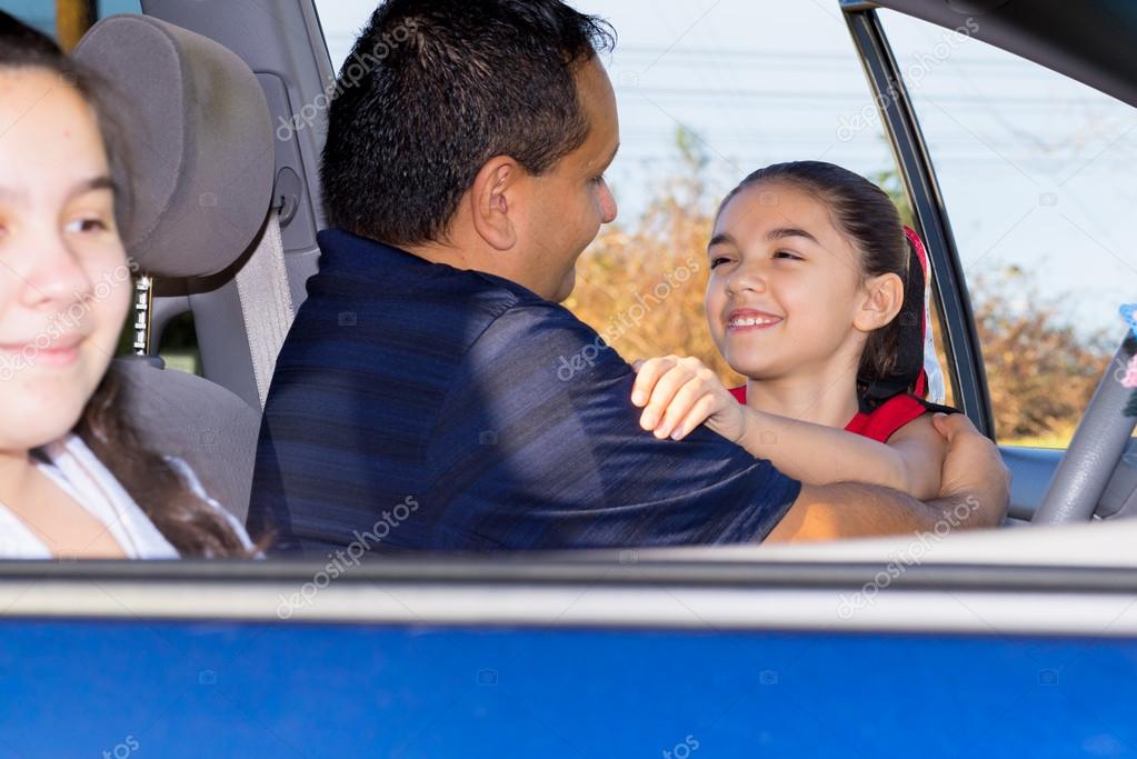 Dad Hugs Daughter At Car