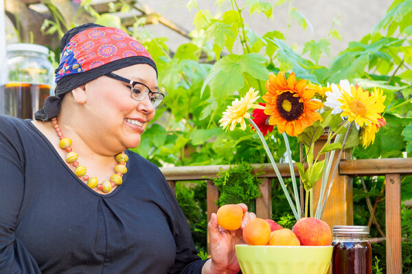 Hispanic Woman Enjoys Evening Snack Outside