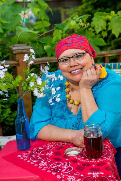 Hispanic Woman Enjoys Evening Snack Outside
