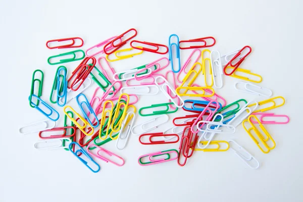 Variety of colorful paper clips on white background — Stock Photo, Image