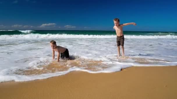 Jungen werden von der Welle nass — Stockvideo