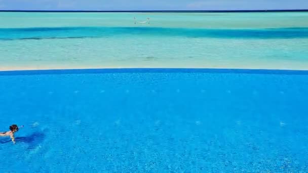 Woman swimming across infinity pool — Stock Video