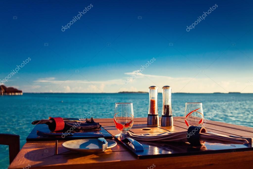 Table setting at tropical beach restaurant Stock Photo by ©mvaligursky ...