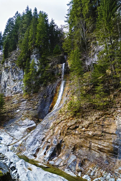 Landscape with a waterfall on colorful rocks — Stock Photo, Image