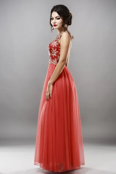 Portrait of a beautiful young woman in red dress. — Stock Photo, Image