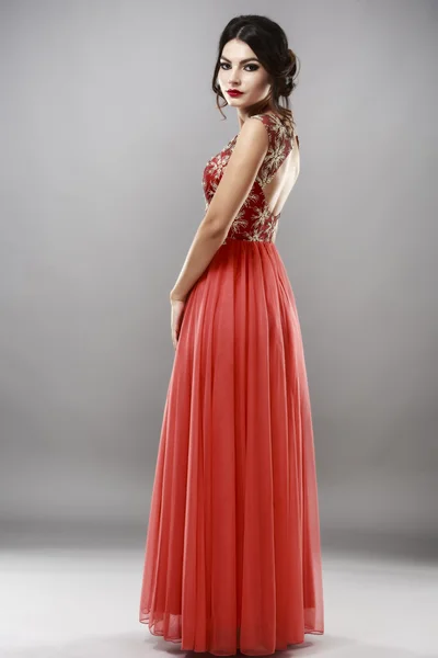 Portrait of a beautiful young woman in red dress. — Stock Photo, Image