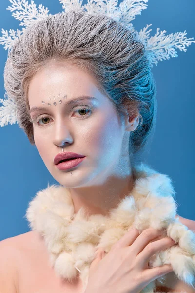 Winter Beauty Woman. Beautiful Fashion Model Girl with Snow Hair style and Make up. Holiday Makeup and Manicure. Winter Queen with Snow and Ice Hairstyle