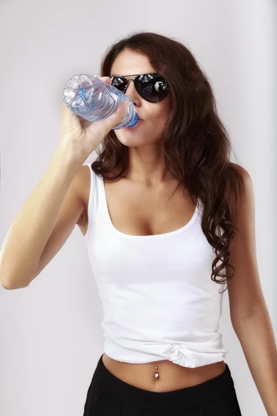 Donna beve acqua dalla bottiglia di plastica — Foto Stock
