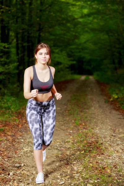 Pretty young girl runner in the forest. — Stock Photo, Image