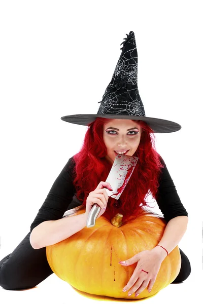 Witch with bloodstained hands with a hatchet in hand sits on a p — Stock Photo, Image