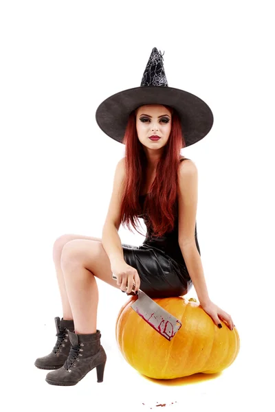 Portrait of a charming red-haired witch holding pumpkin . Hallow — Stock Photo, Image