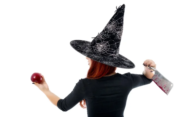 Tricky witch offering a poisoned apple, Halloween theme — Stock Photo, Image