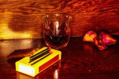 Whiskey drinks with cigars on wooden table clipart