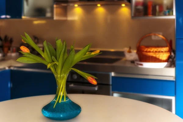 Bunch of tulips on a table in the kitchen — Stock Photo, Image