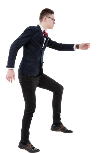 Full length side view of businessman climbing imaginary steps ag — Stock Photo, Image